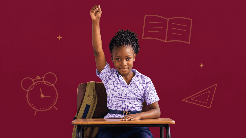 Freemma Academy student enthusiastically raising her hand in classroom
